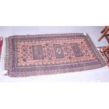 A Bokhara rug with three rectangular guls on a rust ground, multi-bordered in shades of plum,