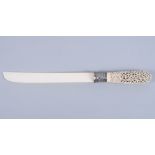 An antique Indian ivory sword/dagger handle, scrolled pierced decoration carved with a