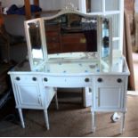 A dove grey painted dressing table of 19th century design with mirrored glass top and triple plate