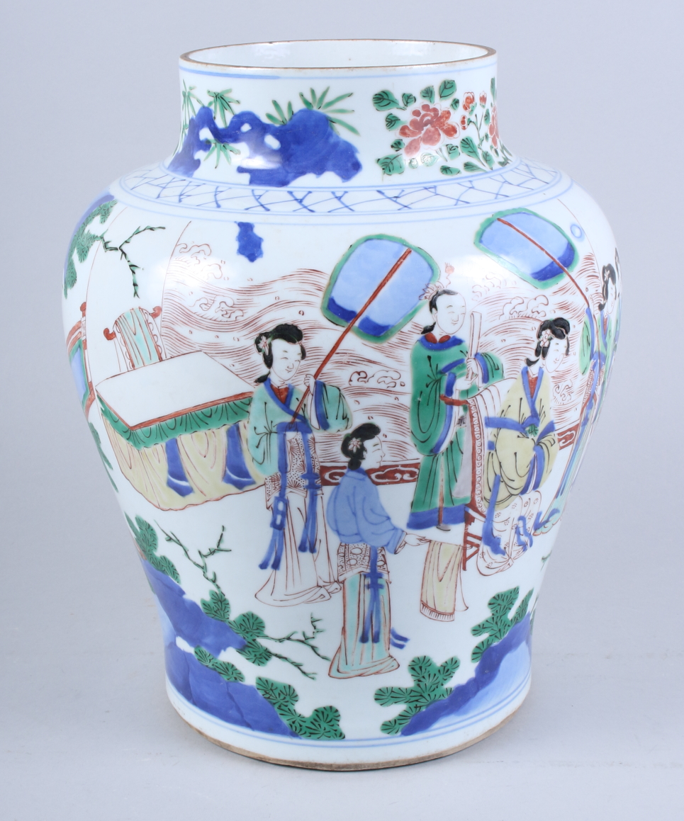 A Chinese Wucai porcelain baluster jar, decorated with figures in a garden court scene, 13" high