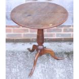 An oak occasional table, on turned column and tripod splay supports, 23" dia