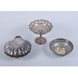 A silver pedestal sweetmeat basket with pierced decoration, a smaller similar bonbon dish and a