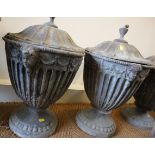 A pair of cast lead fluted urns and covers of 18th century design, 20" high