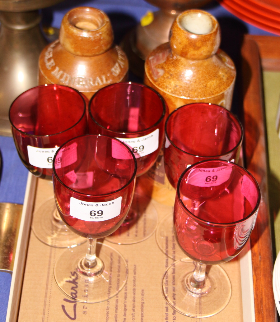 A set of six cranberry wine glasses, a Schweppes stoneware lemonade bottle and another similar