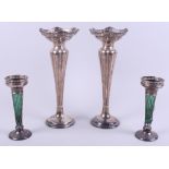 A pair of George V loaded silver faceted conical vases, on stepped circular foot, 11" high, and a