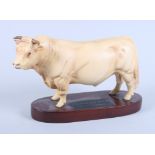 A Beswick Connoisseur model of a standing Charolais bull with matt finish, on an oval wooden base,