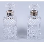 A pair of silver mounted cut glass decanters and stoppers