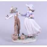 A Lladro figure of a girl and a scarecrow in a pumpkin patch, 10" high
