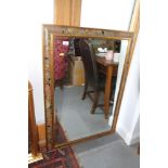 A bevelled edge wall mirror, in floral decorated frame, plate 24" x 36"