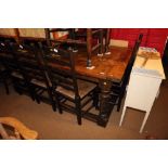 An oak refectory table of 17th century design with cleated planked top, on turned and stretchered