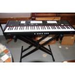 A Johannus "One" electric keyboard and folding stand