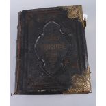 A 19th century black leather bound family Bible with brass mounts