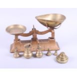 A set of brass kitchen scales and two sets of weights