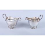 A pair of George V silver sauce boats with scroll handles, on pedestal feet, 21.7oz troy approx