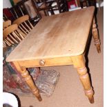 A waxed pine kitchen table, fitted one drawer, on turned supports, top 47" x 36"