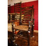 A harlequin set of ten oak ladder back chairs with rush envelope seats (2+8, +2)