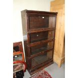 An early 20th century oak four-tier glazed Globe Wernicke bookcase, 63" high