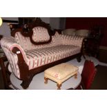 A 19th century walnut framed scroll arm settee, upholstered in a pink and cream Dralon, on splay