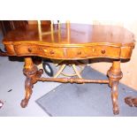A 19th century figured walnut serpentine occasional table, fitted two drawers, with carved splayed