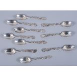 A matched set of ten Victorian silver teaspoons with leaf and flower decorated handles and crest