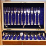 A set of twelve silver plated forks and eleven fish knives, in fitted mahogany canteen