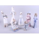 A Lladro figure, woman carrying a basket, 13 " high, a similar Nao figure, and five Nao figures of