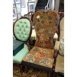 A Victorian mahogany framed spoon back low chair with embroidered tapestry seat and back, on
