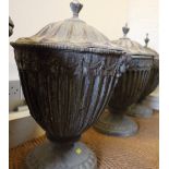 A pair of cast lead fluted urns and covers of 18th century design, 20" high