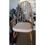 A beech stick back elbow rocking chair