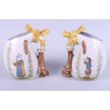 A pair of early 20th century Quimper pottery jugs, naively painted with figures playing