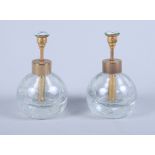 A pair of early 20th century ice glass scent bottles, each atomiser with guilloche enamel of a