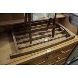 A polished pine bread rack and a folding stand