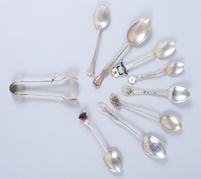 Seven silver teaspoons, various, and a pair of sugar tongs