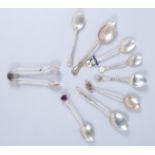 Seven silver teaspoons, various, and a pair of sugar tongs