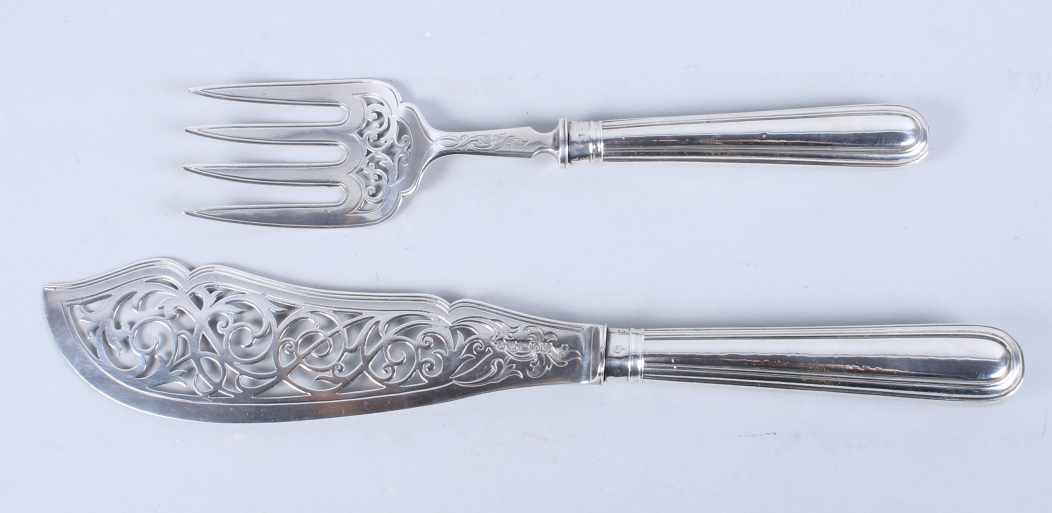 A pair of Victorian silver fish servers with pierced and engraved decoration