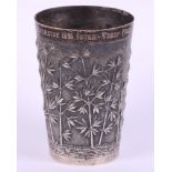 A late 19th century Indian white metal beaker, with embossed bamboo decoration and presentation