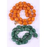 An early 20th century butterscotch amber bead necklace and a green hardstone necklace