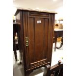A walnut bedside cupboard enclosed panel door, on bracket feet, 16" wide