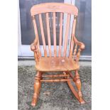 A Stewart Linford cherrywood splat back rocking chair, signed