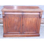 A late Victorian mahogany ledge back chiffonier, fitted two drawers over cupboards, on block base,