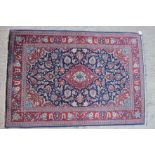 A Kashan rug with all-over floral design and central medallion on a blue ground, 42" x 62" approx