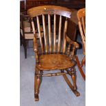 A Stewart Linford carved burr oak lath back rocking chair with panel seat