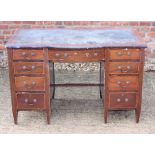 An Edwardian mahogany and line inlaid pedestal break bowfront desk, inset leather top over nine