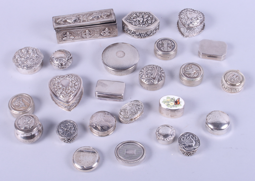 A collection of silver and white metal pill boxes, mostly with embossed decoration, 18.2oz troy