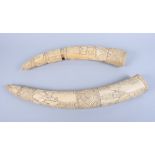 Two early 20th century African ivory tusks, carved with tribal figures, 17" long and 22" long