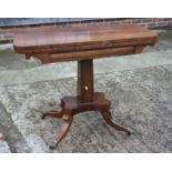 A Regency rosewood fold-over top card table, on central faceted column and quadruple splay
