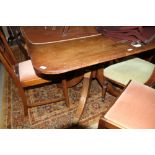 A George III mahogany triple pillar dining table with two leaves, on reeded quadraform splay