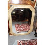 An octagonal gilt painted bevelled edge wall mirror, plate 27" x 19"