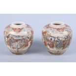A pair of Meiji period Japanese Satsuma baluster jars, decorated with figures in a courtyard, 4 1/2"
