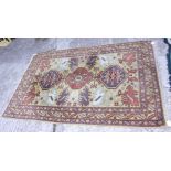 A Kazak design rug with three medallions on a yellow ground, 78" x 50" approx